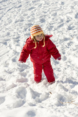 Little girl playing outdoors in snow