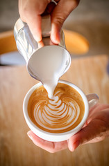 Cup of coffee latte in coffee shop.