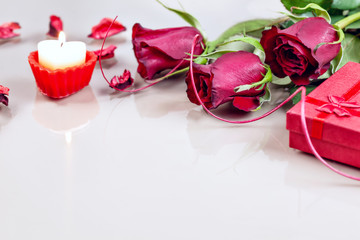 Valentine's day - red roses with gift box and candle