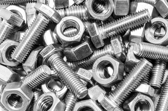 Industrial strong steel nuts bolts and washers mixed together / A mixture of industrial strong steel nuts bolts and washers