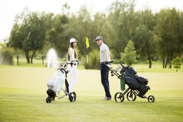 Young couple at golf cart