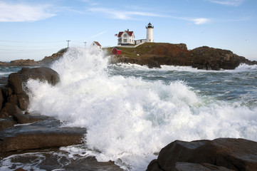 Waves crashing at high tide near Cape Neddick llighthouse, also known as Nubble light, in Maine.
