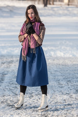 Happy girl having fun on ice skates.