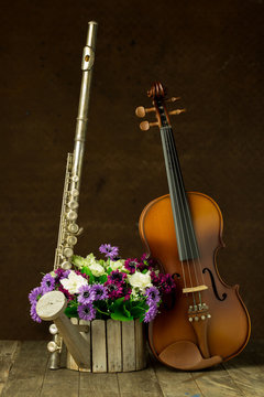 Silver flute and violin on old steel background