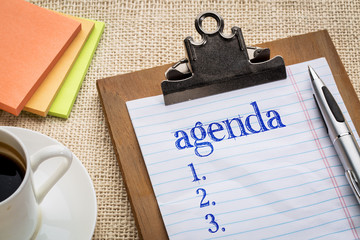 agenda list on clipboard and coffee