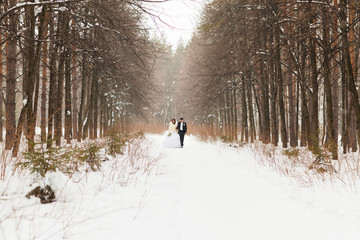 bride and groom in the winter woods