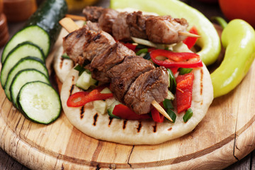 Grilled meat skewer with pita bread