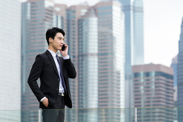 Businessman make a call on cellphone at outdoor