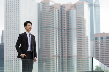 Young asian businessman standing at outdoor