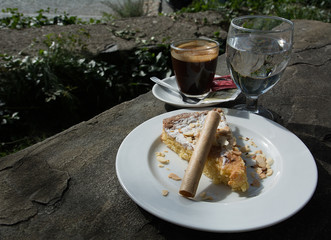 North Spain, Catalonia almond cake with an espresso on a black stone table