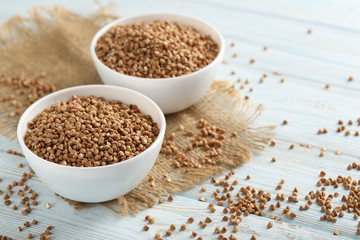 Buckwheat seeds in bowl on a blue wooden table
