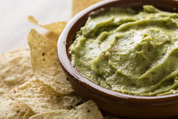 Guacamole with avocado, lime, tomato, and cilantro with tortilla