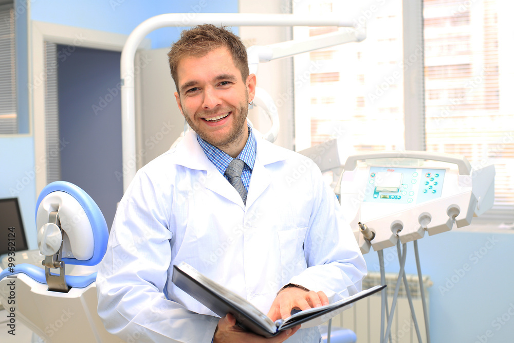 Wall mural dentist writes a patient a prescription in medical office