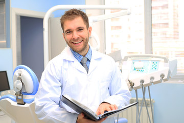 Naklejka na ściany i meble Dentist writes a patient a prescription in medical office