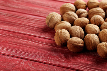 Walnuts on a red wooden table