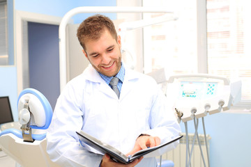 Naklejka na ściany i meble Dentist writes a patient a prescription in medical office