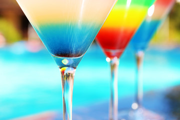 Cocktail on swimming pool background