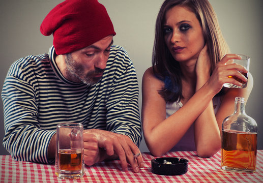 Young Couple Drinking Beer And Whiskey