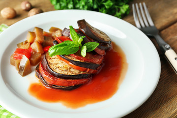 Ratatouille on plate, on table background