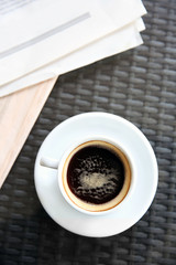 Cup of tasty coffee and newspapers in cafe