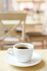 Cup of tasty coffee on cafe background