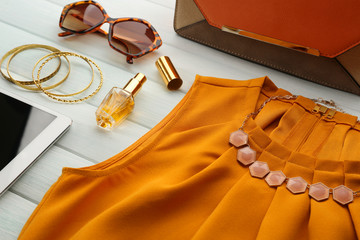 Bright fashion look on wooden background, close up