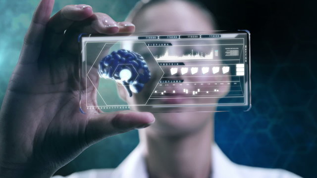 Caucasian American female scientist using touchscreen technology showing brain