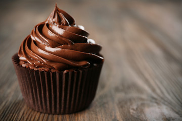 Chocolate cupcake on dark wooden background