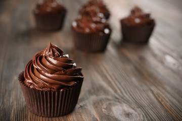 Chocolate cupcakes on dark wooden background