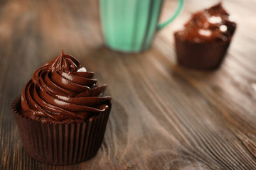 Chocolate cupcakes served with drink on table