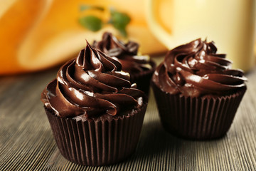 Chocolate cupcakes with drink on table