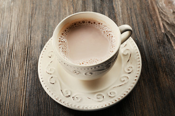 Vintage cup of cacao on wooden background