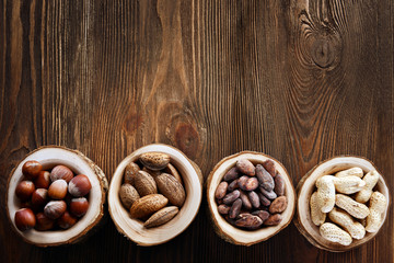 Assortment of tasty nuts on wooden background