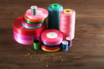Spools of color ribbon on wooden background
