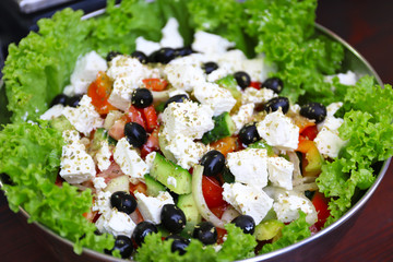 Greek salad in bowl on a table