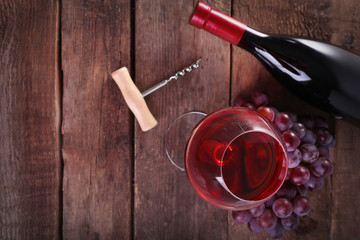Grapes and wine on wooden background
