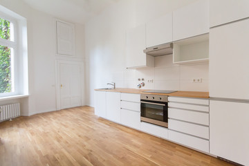 white kitchen - renovated flat with wooden floor,