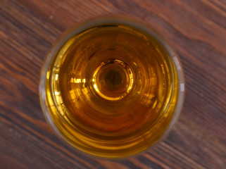 Glass of wine on wooden table. Top view