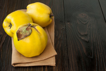 Ripe quinces on vintage wooden table. Copy space
