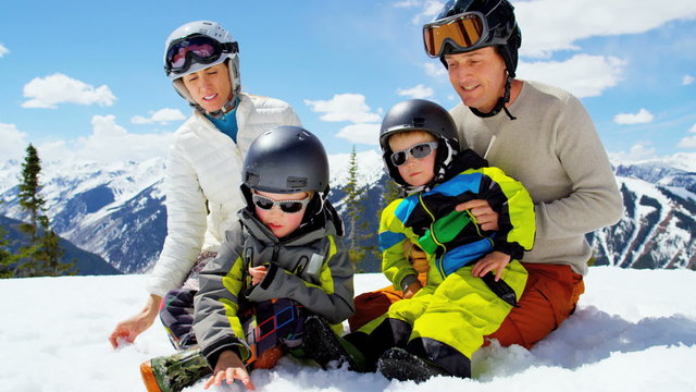 Caucasian family snow skiing resort children boys healthy outdoor lifestyle