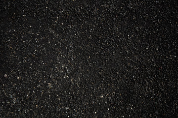 The texture of fresh asphalt lined up close. Pavement
