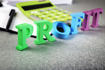 Alphabet Profit and calculator on table