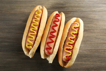 Tasty hotdogs on wooden background