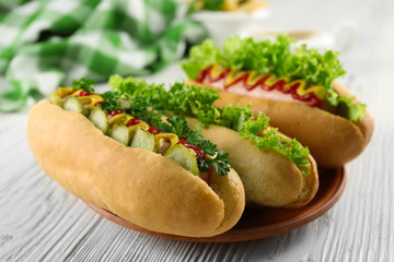 Delicious hot-dogs on white wooden table, close up