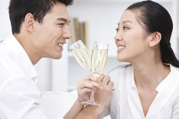 Happy young couple drinking champagne