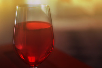 Glass of red wine on blurred background