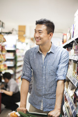 Young man shopping in supermarket