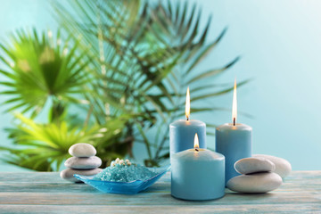 Fototapeta na wymiar Blue candles with spa salt on table