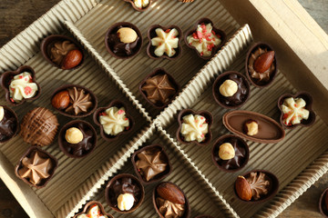 Different chocolate candies in paper box, close up
