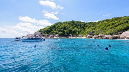 Tourists enjoyed snorkelling on blue sea and sky during summer at Ko Ba Ngu Island in Mu Ko Similan National Park, Phang Nga province, Thailand, 16:9 widescreen